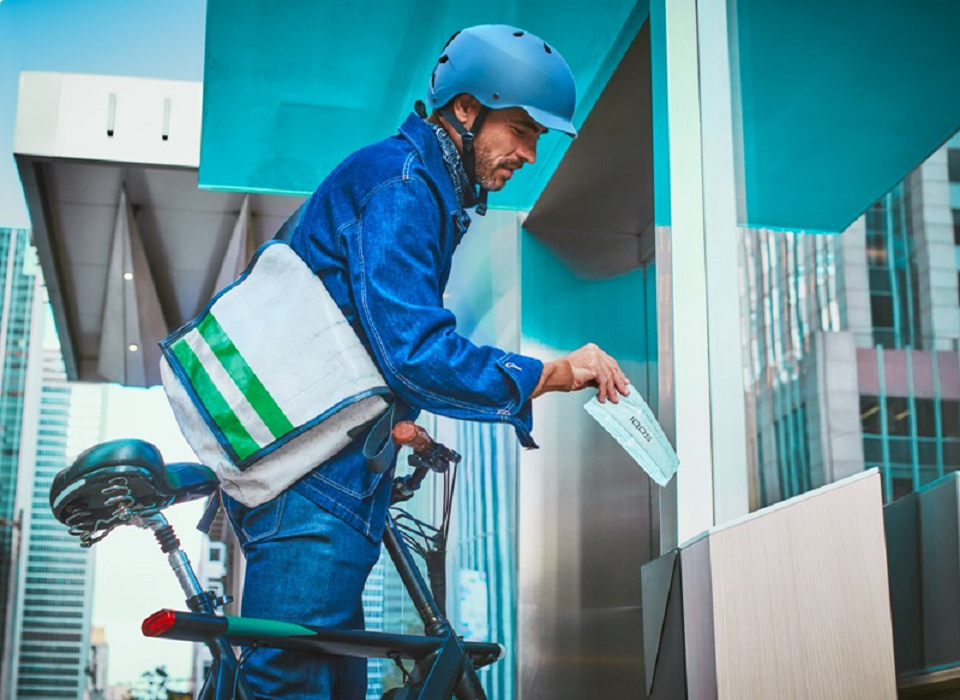 Man placing parcel into recycling box